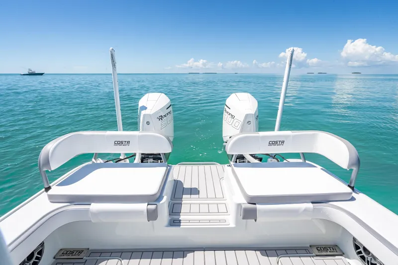 Slide: The Image of 2022 Costa Custom Boats 264 on clear blue water, featuring dual engines. - 44