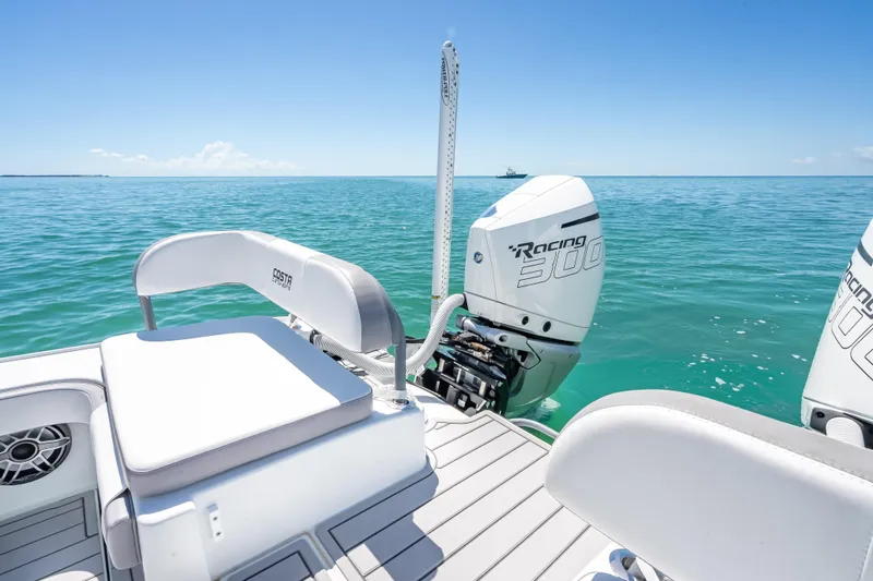 Slide: The Image of 2022 Costa Custom Boats 264 with Racing 300 engines on clear blue water. - 45
