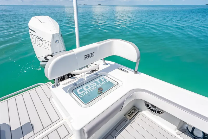 Slide: The Image of 2022 Costa Custom Boats 264 on turquoise water, featuring a powerful outboard motor. - 46
