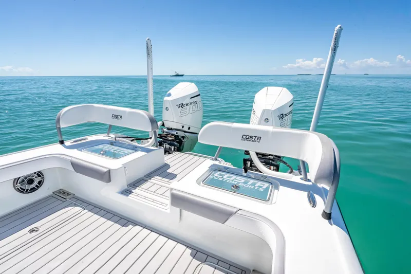 Slide: The Image of 2022 Costa Custom Boats 264 on clear blue ocean with twin Racing 300 engines. - 47