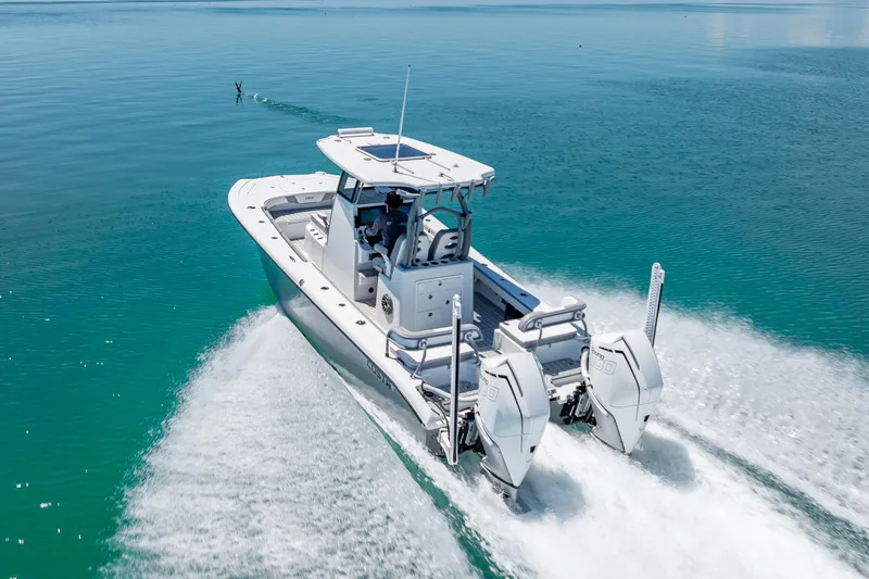 Slide: The Image of 2022 Costa Custom Boats 264 cruising on clear blue water, showcasing powerful dual engines. - 5