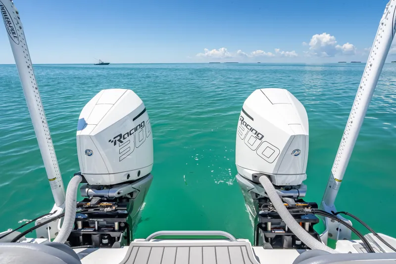 Slide: The Image of 2022 Costa Custom Boats 264 with twin Racing 300 engines on turquoise water. - 51