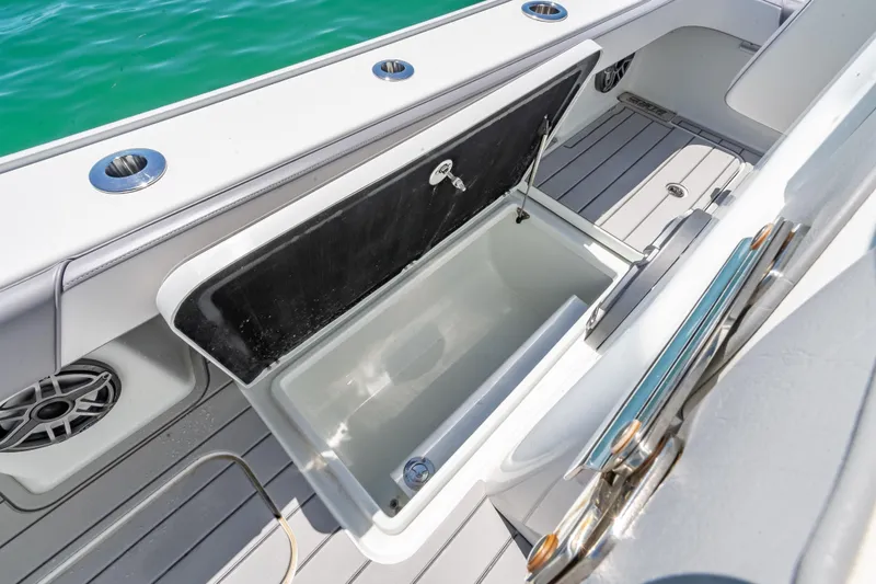 Slide: The Image of Open storage compartment on 2022 Costa Custom Boats 264, with sleek deck design and ocean view. - 52