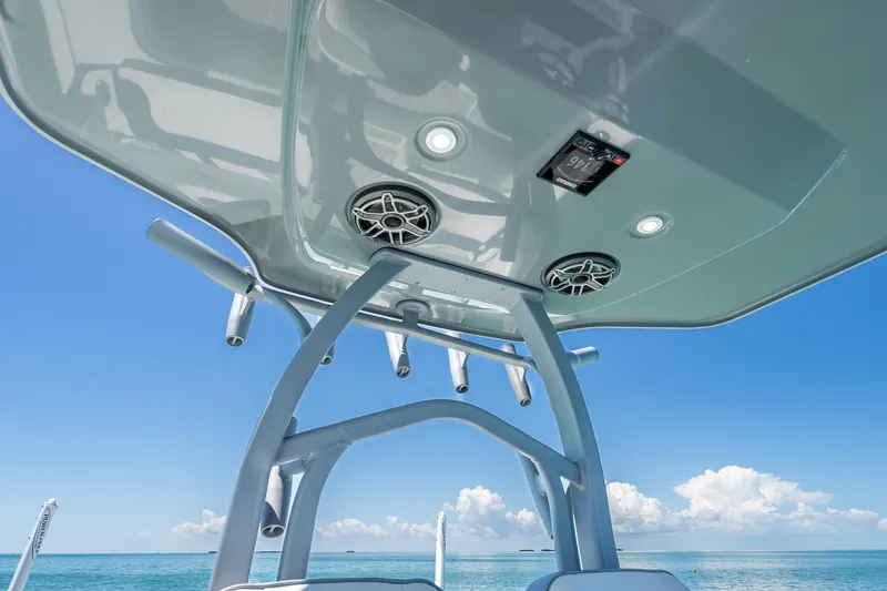 Slide: The Image of 2022 Costa Custom Boats 264 T-top with speakers, ocean view, clear blue sky. - 55