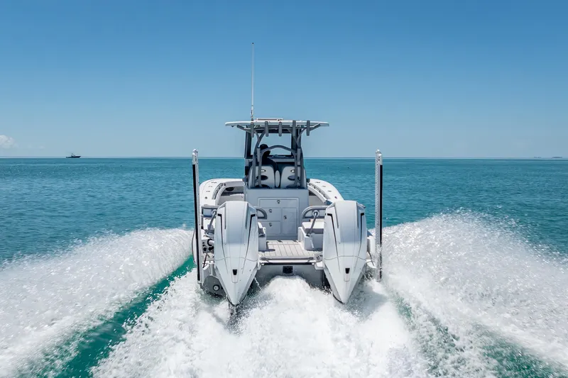 Slide: The Image of 2022 Costa Custom Boats 264 cruising on open water, rear view. - 6