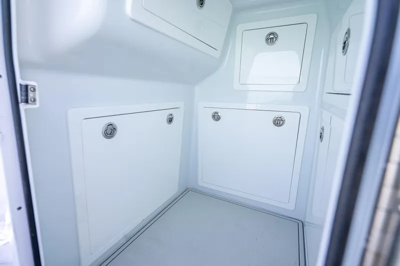 Slide: The Image of Interior storage compartments of 2022 Costa Custom Boats 264 model. - 60