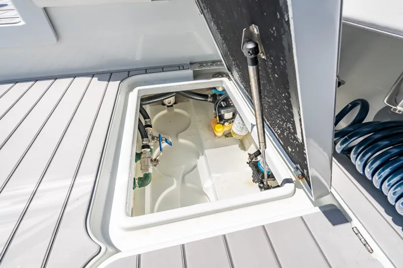 Slide: The Image of Open hatch on 2022 Costa Custom Boats 264, revealing internal components and storage. - 61