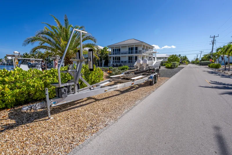 Slide: The Image of 2022 Costa Custom Boats 264 on trailer near waterfront home, sunny day. - 63