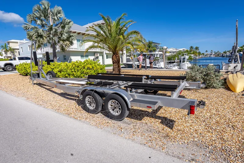 Slide: The Image of Trailer for 2022 Costa Custom Boats 264, parked near waterfront homes and palm trees. - 66