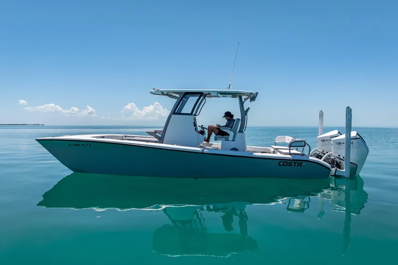 Slide: The Image of 2022 Costa Custom Boats 264 on calm blue water, side view. - 7