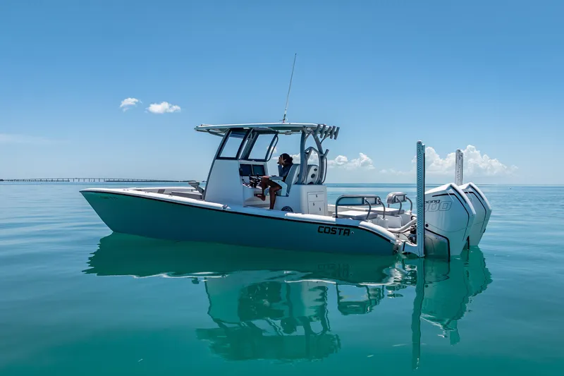 Slide: The Image of 2022 Costa Custom Boats 264 on calm blue water under clear sky. - 8