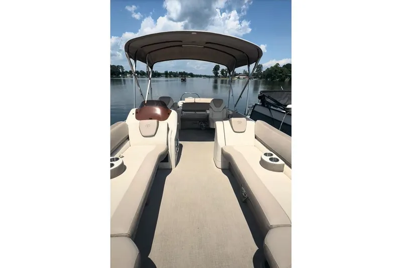 Slide: The Image of 2023 Tahoe Pontoon Cascade Rear Lounger on a serene lake with clear skies. - 3