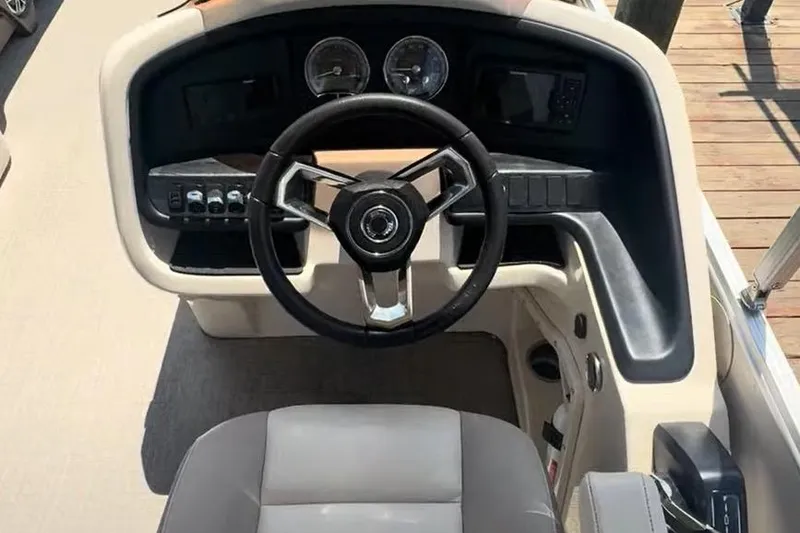 Slide: The Image of 2023 Tahoe Pontoon Cascade Rear Lounger dashboard with steering wheel and controls. - 5