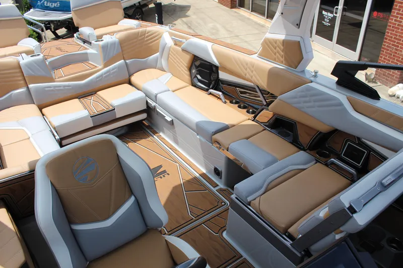 Slide: The Image of 2024 Tigé Ultré 25ZX boat interior with luxurious tan and gray seating, cup holders, and modern design. - 10