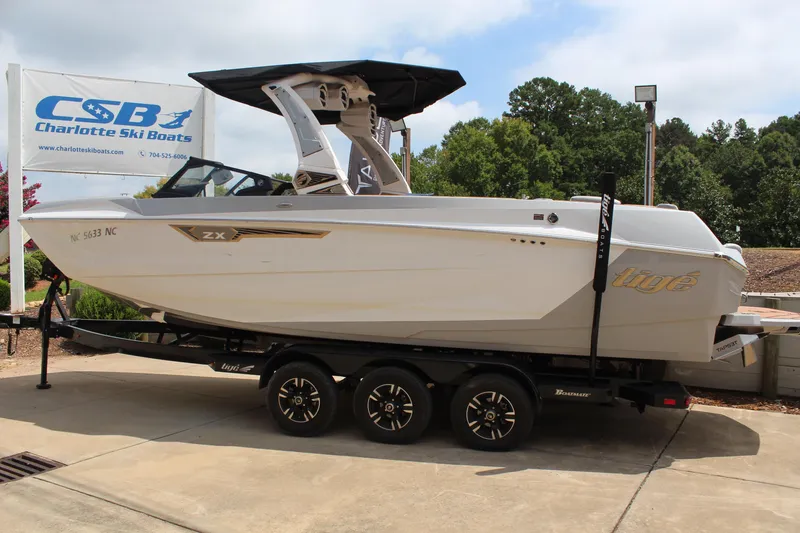 Slide: The Image of 2024 Tigé Ultré 25ZX boat on trailer at Charlotte Ski Boats dealership. - 16