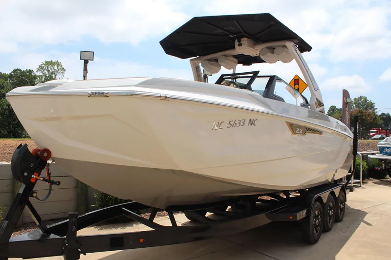 Slide: The Image of 2024 Tigé Ultré 25ZX boat on trailer, sleek design, outdoor display. - 17
