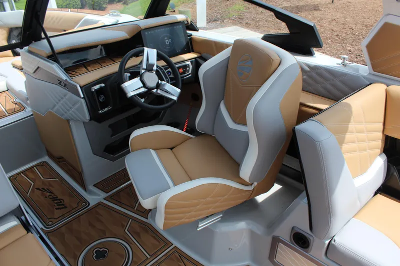 Slide: The Image of 2024 Tigé Ultré 25ZX boat interior with luxury seating and modern dashboard design. - 6