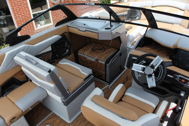 Slide: The Image of 2024 Tigé Ultré 25ZX boat interior with luxurious tan and white seating, modern dashboard. - 7
