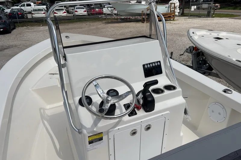 Slide: The Image of 2026 May-Craft 192 boat console with steering wheel and controls, parked outdoors. - 11