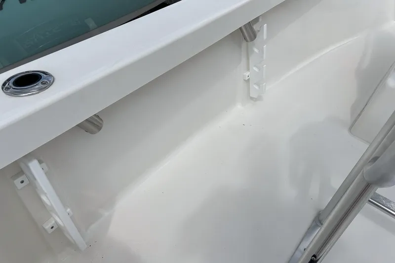 Slide: The Image of 2026 May-Craft 192 boat interior, featuring white deck and rod holders. - 13