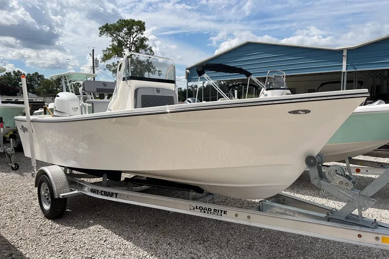 Slide: The Image of 2026 May-Craft 192 boat on trailer, parked outdoors under a cloudy sky. - 14