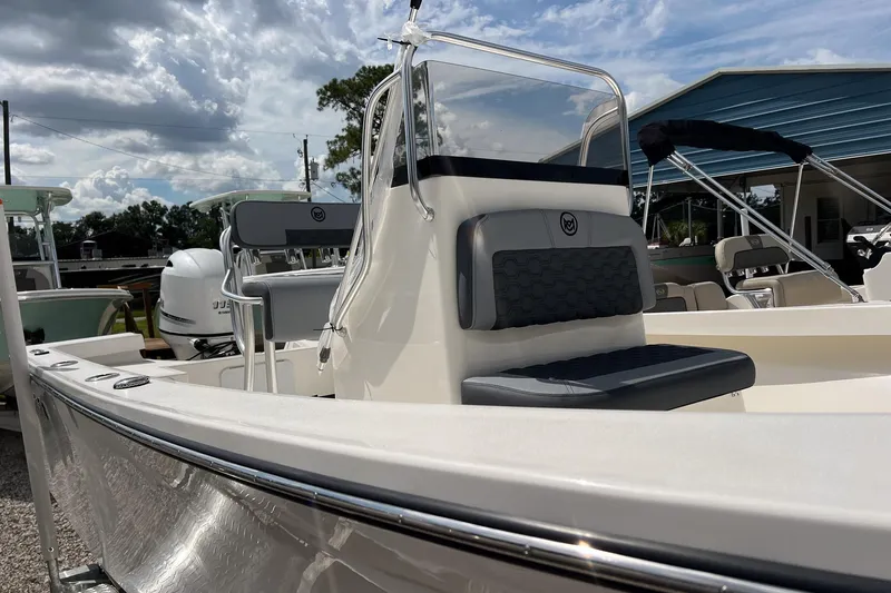 Slide: The Image of 2026 May-Craft 192 boat with sleek design and modern seating, under a partly cloudy sky. - 15