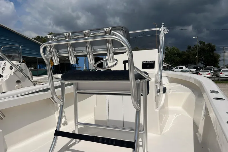 Slide: The Image of 2026 May-Craft 192 boat interior with seating and console under cloudy sky. - 18