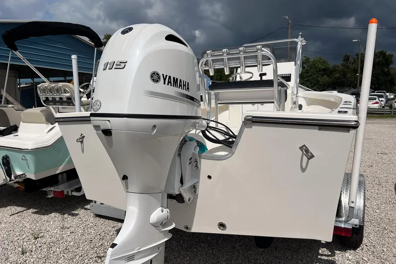 Slide: The Image of 2026 May-Craft 192 boat with Yamaha 115 outboard motor, parked on gravel. - 5