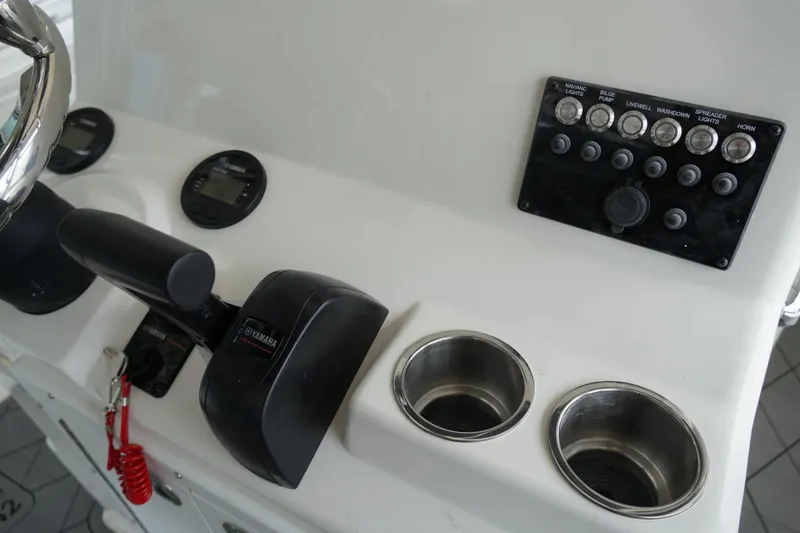 Slide: The Image of Control panel of 2026 Defiance CATALINA 192 boat with Yamaha throttle and cup holders. - 11