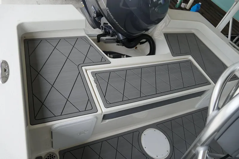 Slide: The Image of 2026 Defiance CATALINA 192 boat deck with gray non-slip flooring and motor. - 15