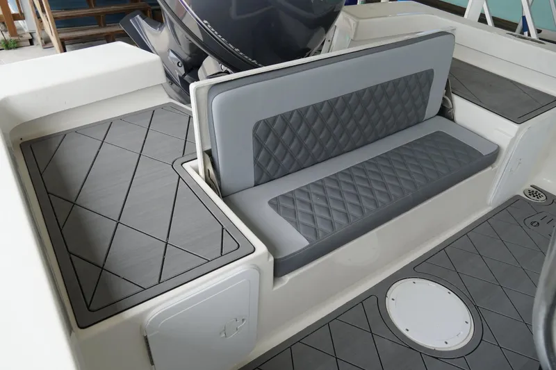 Slide: The Image of Interior seating of 2026 Defiance Catalina 192 boat with quilted gray upholstery. - 16