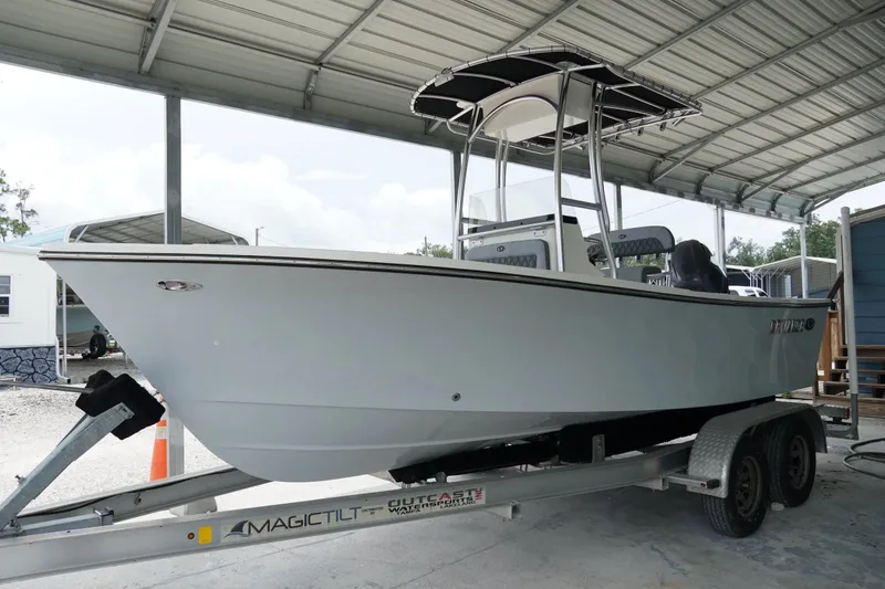 Slide: The Image of 2026 Defiance CATALINA 192 boat on trailer under a metal canopy. - 2