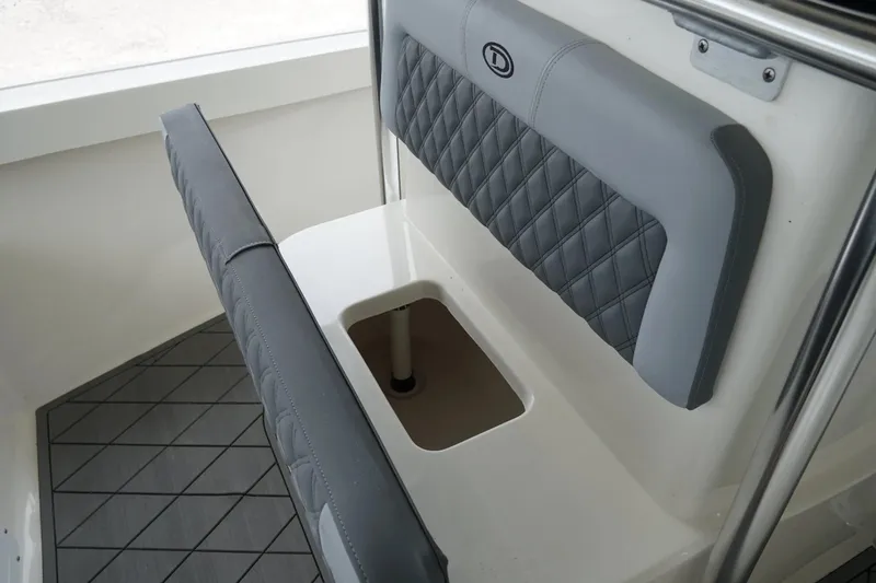 Slide: The Image of 2026 Defiance CATALINA 192 boat interior with gray quilted seating and storage compartment. - 22