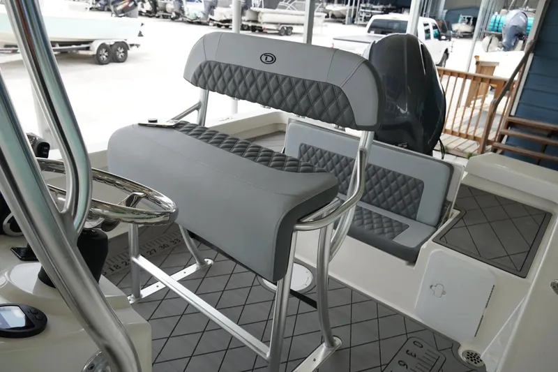 Slide: The Image of 2026 Defiance CATALINA 192 boat interior with cushioned seating and steering wheel. - 23