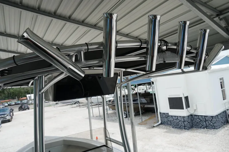 Slide: The Image of 2026 Defiance CATALINA 192 boat with stainless steel rod holders under a metal canopy. - 24