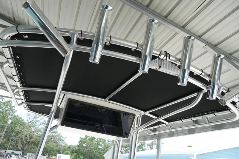 Slide: The Image of T-top of 2026 Defiance CATALINA 192 boat with rod holders and black canvas. - 25