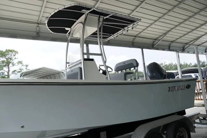 Slide: The Image of 2026 Defiance CATALINA 192 boat under a metal canopy, side view. - 3
