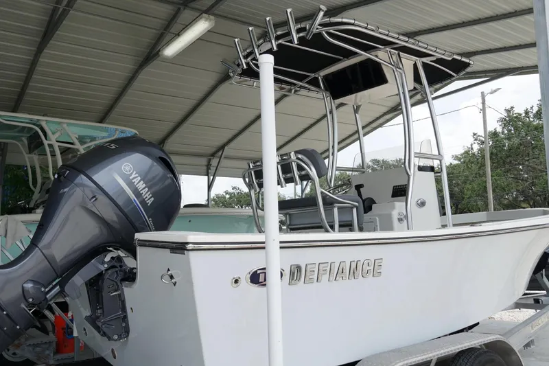 Slide: The Image of 2026 Defiance Catalina 192 boat with Yamaha outboard motor under a metal canopy. - 4