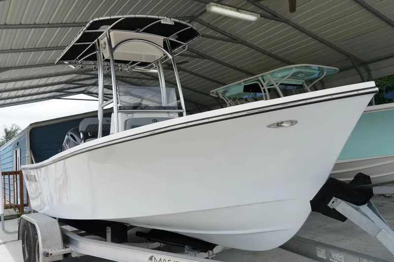 Slide: The Image of 2026 Defiance CATALINA 192 boat on trailer under metal shelter. - 5