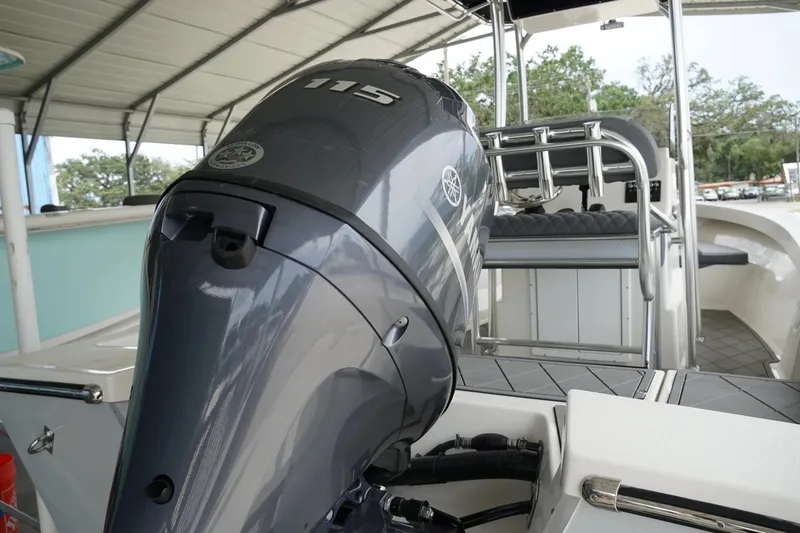 Slide: The Image of 2026 Defiance CATALINA 192 boat with Yamaha 115 outboard motor, under covered dock. - 7
