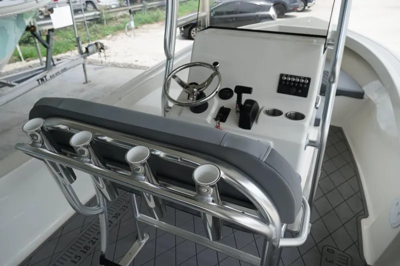 Slide: The Image of 2026 Defiance Catalina 192 boat console with steering wheel and rod holders. - 8