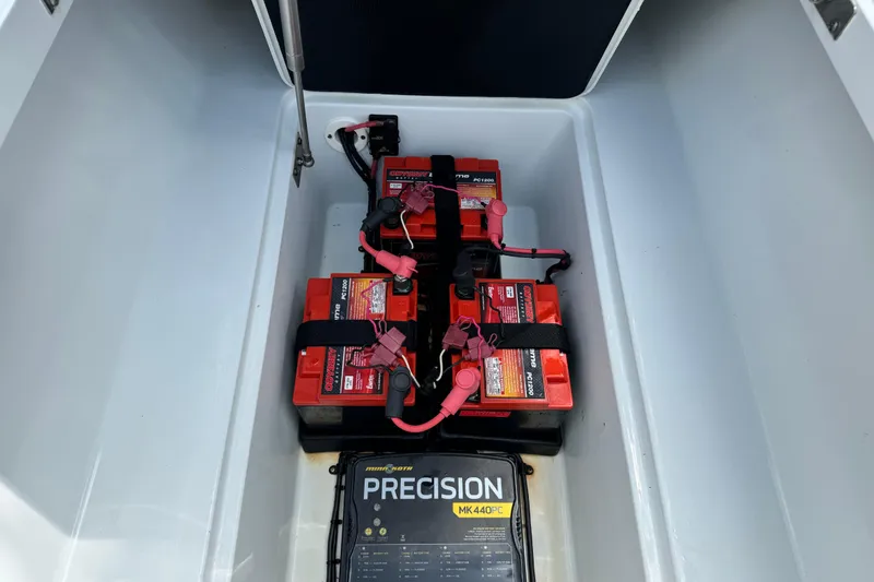 Slide: The Image of 2020 Yellowfin 24 Bay CE boat battery compartment with Odyssey batteries and Precision charger. - 11