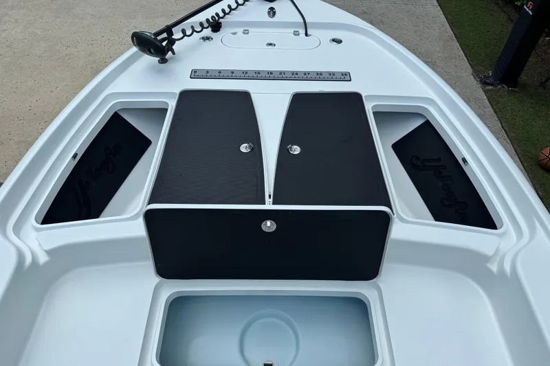 Slide: The Image of 2020 Yellowfin 24 Bay CE boat deck with storage compartments and ruler. - 12