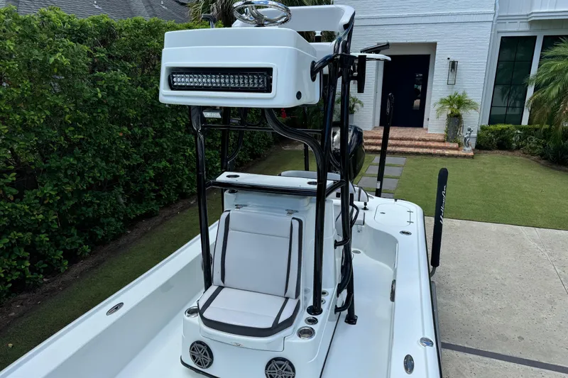 Slide: The Image of 2020 Yellowfin 24 Bay CE boat with seating and LED light bar, parked in driveway. - 14