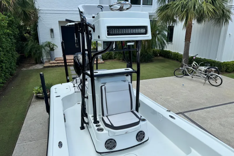 Slide: The Image of 2020 Yellowfin 24 Bay CE boat with seating and tower, parked in a driveway. - 15