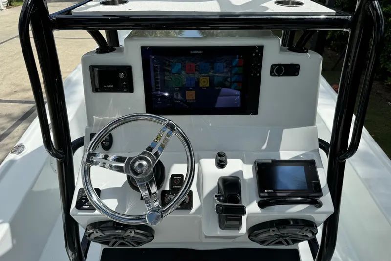 Slide: The Image of 2020 Yellowfin 24 Bay CE boat dashboard with steering wheel and electronic controls. - 17