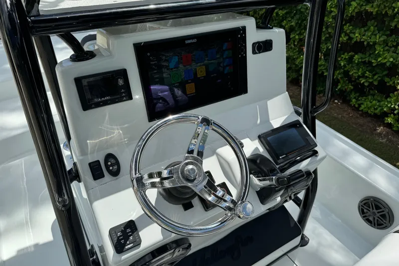 Slide: The Image of 2020 Yellowfin 24 Bay CE boat console with steering wheel and electronic displays. - 18
