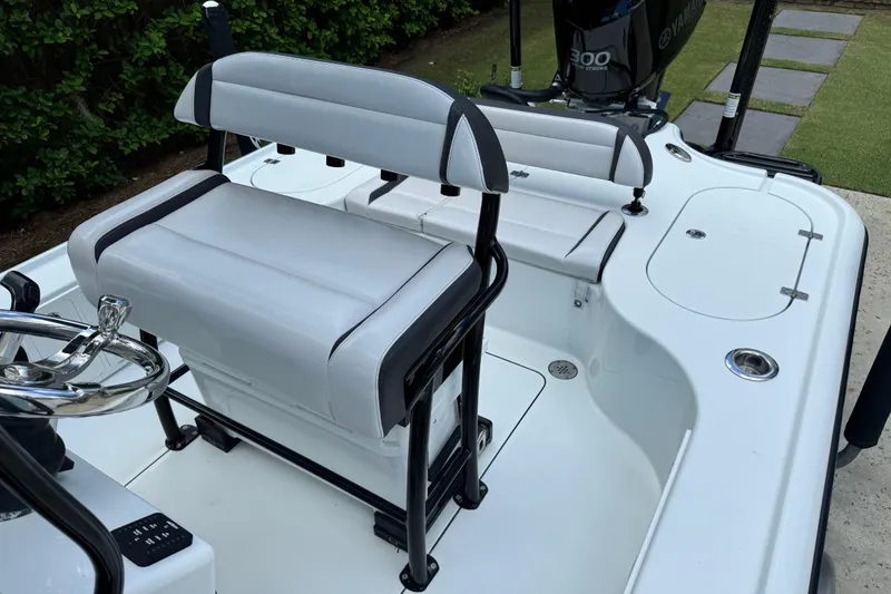 Slide: The Image of 2020 Yellowfin 24 Bay CE boat interior with seating and Yamaha 300 engine. - 21