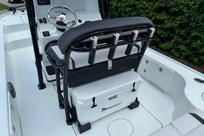 Slide: The Image of 2020 Yellowfin 24 Bay CE boat interior with steering wheel and Yeti cooler. - 23