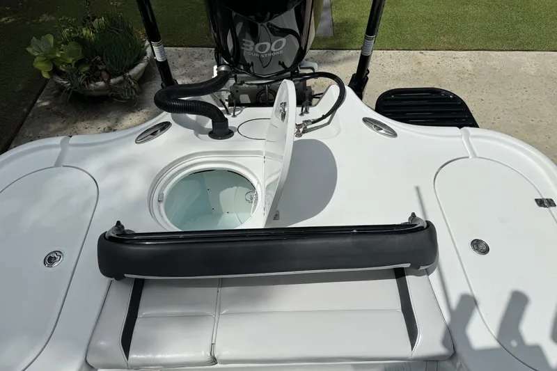 Slide: The Image of 2020 Yellowfin 24 Bay CE boat with open hatch and seating area. - 25